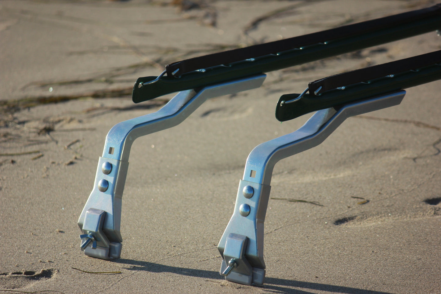 Image of the clamps close up view that connect the racks to the car sitting on the beach 